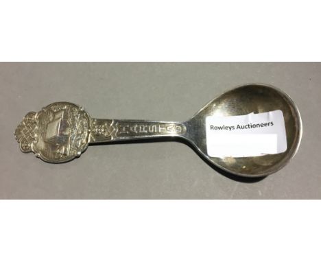 A white metal Scandinavian caddy spoon