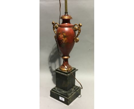 A red toleware lamp