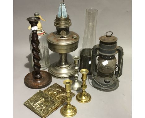 A vintage oil lamp, lantern, candlesticks, etc.