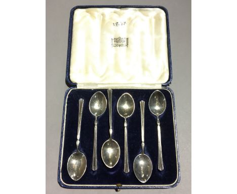 A cased set of enamel decorated silver teaspoons (approx 2 troy ozs)