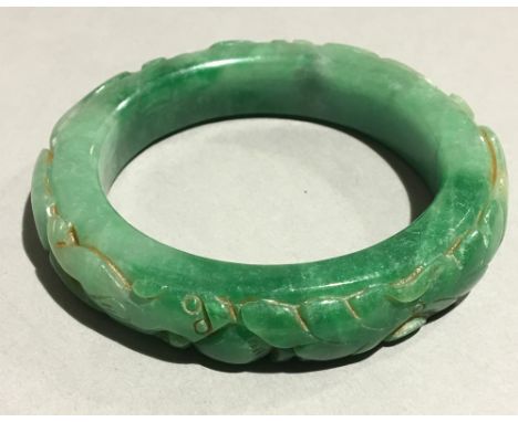 A carved jade bangle