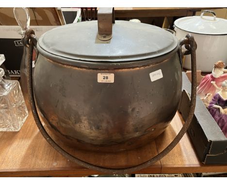 A copper cooking pot and cover. 19" wide
