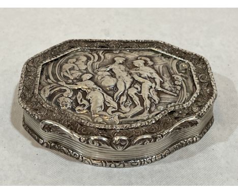 A 19th century silver snuff box with repousse decorated lid, the interior gilded. 3¼" wide. 3ozs 8dwts