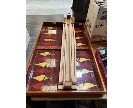 An artist's easel and a mahogany lacquered gaming board