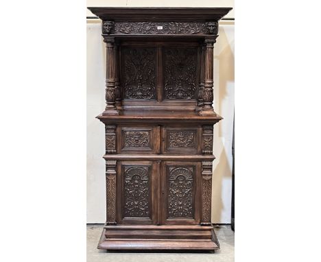 A 19th century Flemish oak buffet cupboard, heavily carved in 'gothic' style, the open upper part with fluted pilasters, over