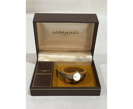 A Longines 9ct cased lady's wristwatch, both case and integral bracelet marked 375. Gold weight 15g. Original box. Back engra