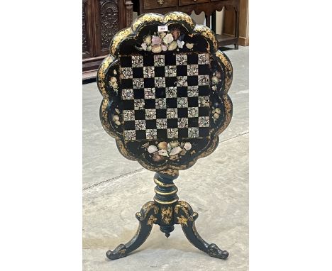 A Victorian papier-mache snap-top pillar table, the chequer board top inlaid with mother-of-pearl parcel gilded and painted w