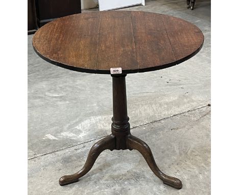A 19th century oak snap-top pillar table on tripod support. 27" diameter