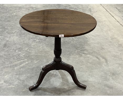 A 19th century oak pillar table on tripod support. 29" diam.