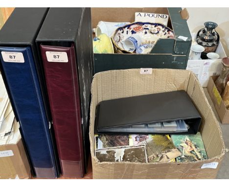A box of postcards with cigarette cards and two empty cigarette card albums