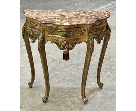 A giltwood console table in the French manner, with frieze drawer under a shaped specimen marble top, raised on cabriole legs