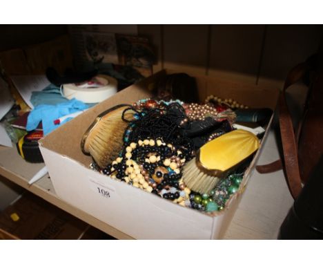 A box of various costume necklaces; a leather stud box; dressing table brushes with enamel decoration etc.