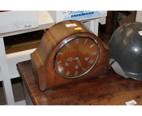 An oak cased three hole mantel clock 