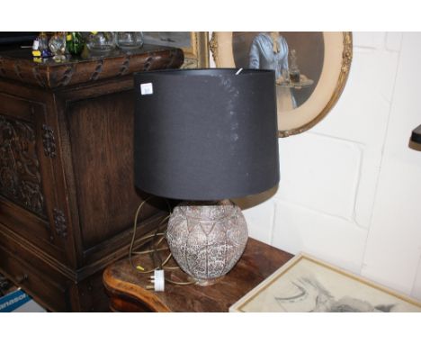 An Eastern style copper table lamp with shade