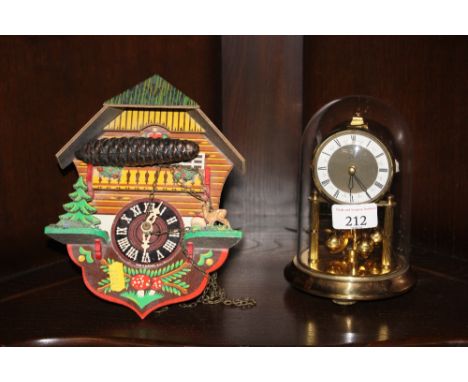A painted cuckoo clock; and an anniversary clock