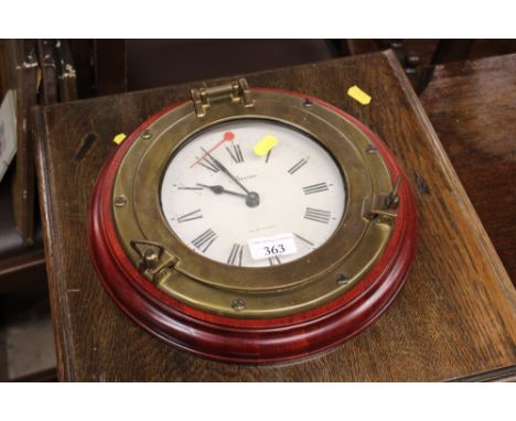 A modern battery powered porthole style wall clock 