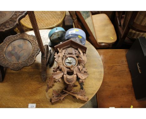 A Black Forest style cuckoo clock; a jasperware Royal Norfolk mantel clock; and a Smiths alarm clock