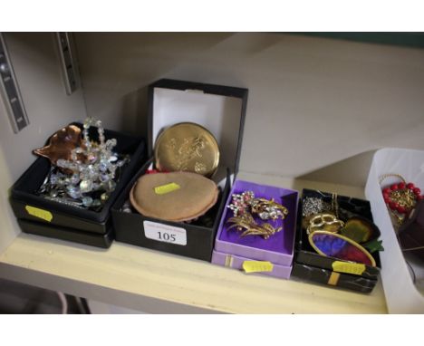 Four small boxes of various costume jewellery; and a compact 