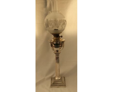 A silver plated oil lamp with a Corinthian column base. Gold and Silver Smiths Company, Regent St.73cm h with shade.Condition