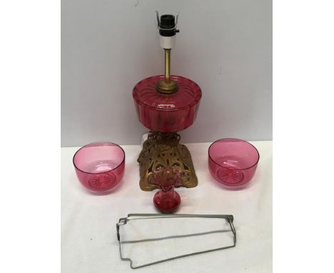 Cranberry glass electrified oil lamp with cast iron base 39 cm H,  two cranberry bowls 11.5 cm w and a small vase 9 cm H.Cond