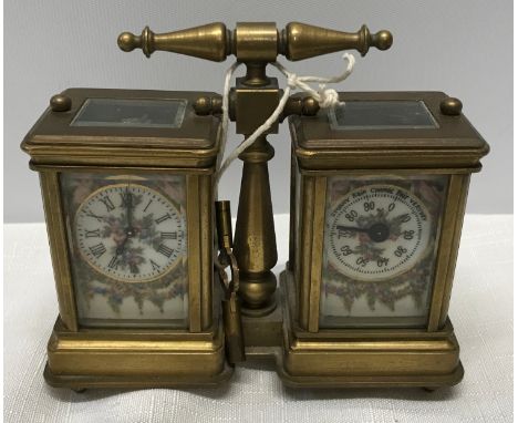 A small brass carriage clock and barometer with carry handle and double key and painted pottery panels to all sides. 12.5cm w