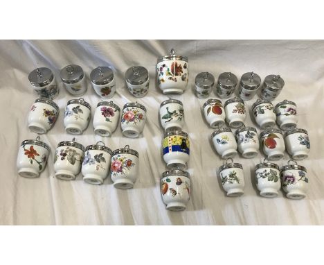 Thirty one Royal Worcester egg coddlers. 12 x 8.5cms h, floral one large animals pattern 10cms, 3 animals pattern 8.5cms h an