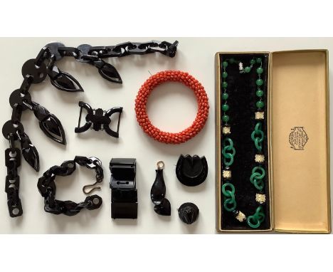 A collection of jewellery to include a hand carved coral beaded bracelet 9.5cm, a oriental style necklace with green and blac