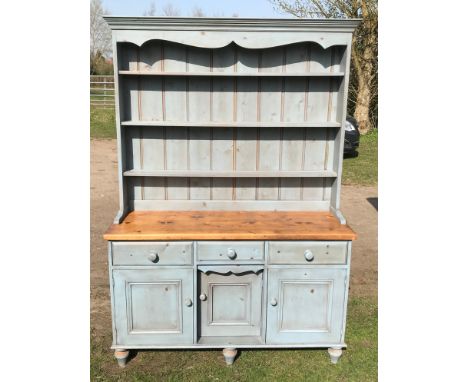 A light blue painted pine welsh dresser with 3 drawers, 3 cupboards and back with 3 shelves. 132cm w x base 79cm h. Overall 1