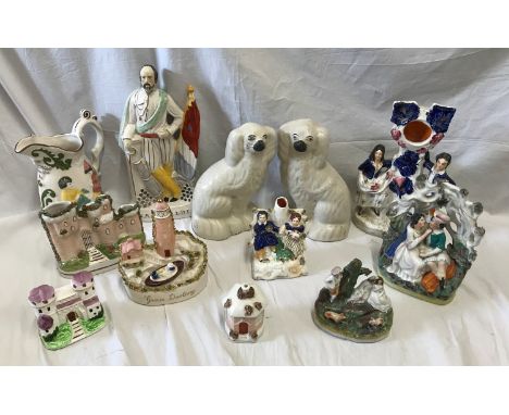 A selection of Staffordshire pottery to include a watch stand 28cms h, a young couple under arch 22cms h, a pair of spaniel d