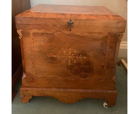 Walnut inlaid box with lift up lid and white ceramic castors. 51 w x 34 d x 55cms h.Condition ReportGood condition.