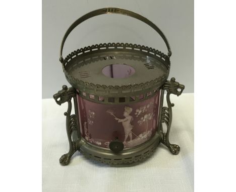 A small metal oil lamp with Mary Gregory pink shade on a stand with three lion's heads with clawed feet. 12cm h , with handle