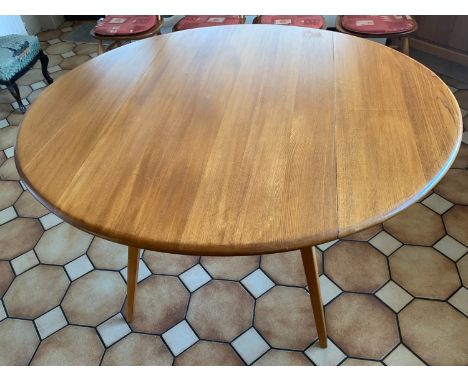 A mid century round drop leaf dining table possibly Ercol. 113cm x 124cm.Condition ReportMarks to top.