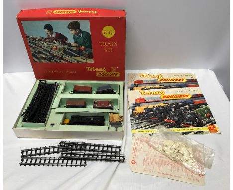 Trian R3Q train set, clockwork 00 guage, boxed with two Triang fourth edition brochures and small plastic trackside figures.C