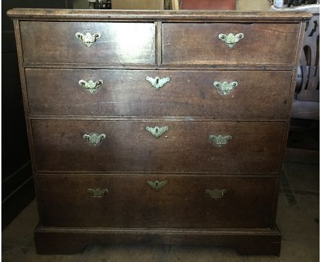 A 19thC oak 2 over 3 chest of drawers, brass handles, bracket feet. 90 h x 53 d x 92cms w.Condition: Ring marks and stains to