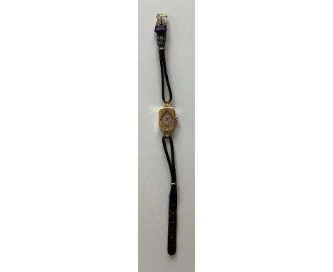 An Art Deco lady's 18ct gold wrist watch with black thin leather straps, diamond shaped clock face with numerical dial and en