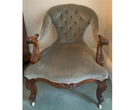 Victorian Walnut framed button back open armchair on cabriole legs with ceramic and brass castors.Condition ReportGood condit