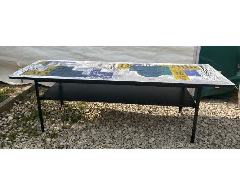 A Mid Century Modern John Piper coffee table with graphic colourful picture to table top and shelf to middle, black metal fra