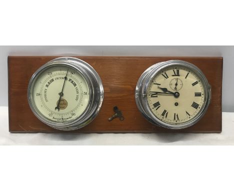 A chrome cased ships clock and aneroid barometer mounted on pine by Cooke of Hull. Back plate width 20cms. Face width 14,5cms