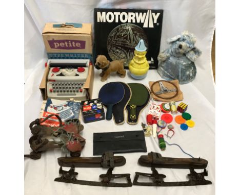 Mixed lot of toys including mid century skates and roller skates, table tennis bats, Playcraft Petite Typewriter, nodding dog