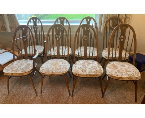 A set of eight Ercol dining chairs with swan design to include 2 carvers. All with cushions.Condition ReportGood condition.