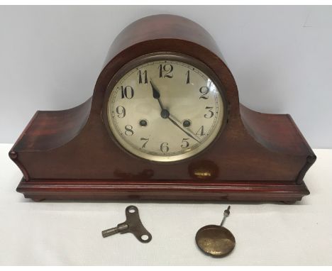 A mahogany cased mantle clock  with DRM brass movement 25cms h  x 14cms d x 42cms w.  with a steel face 14cms w.Condition Rep