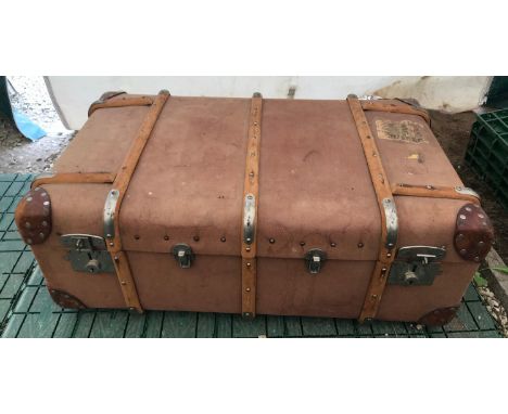 A large wood bound brown canvas travel trunk made by PAKAWA England with fitted tray interior. 94cms w x 56cms d x 35cms h.Co