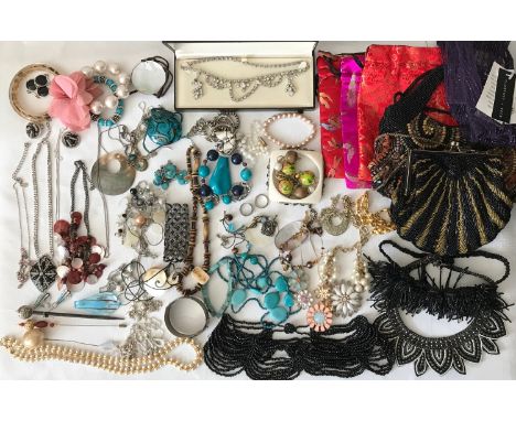 A large collection of modern costume jewellery including necklaces, bracelets, hair pins, small beaded hand bags, drawstring 