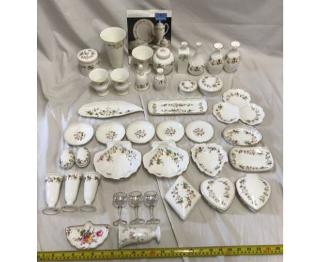 A collection of Wedgwood Mirabelle ornaments to include Vases from 17.5cms to 9.5cms h, a ginger jar 10.5cms h, various trink