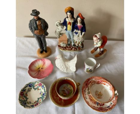 A selection of ceramics comprising a Royal Doulton figurine "Arnold Bennet" HN 4360, a Royal Dux hand painted girl on skis, a