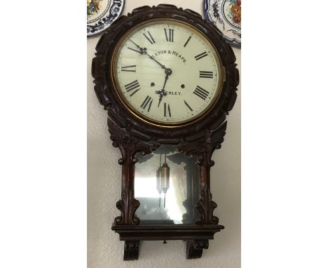 A 19thC carved mahogany wall clock with visible pendulum. Rexton + Heap Beverley. 73 h x 42 w.