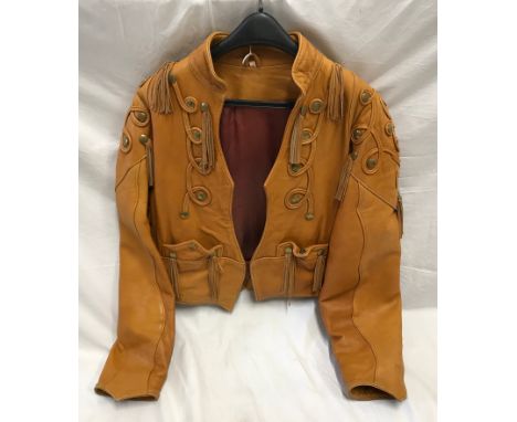 Ladies light brown leather waist length jacket, size M, brass studs and leather tassels.Condition ReportLight signs of use, m
