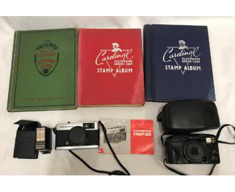 Three stamp albums, two Cardinal. one Triumph part filled with British and World used stamps.An Olympus Trip 35 camera with f