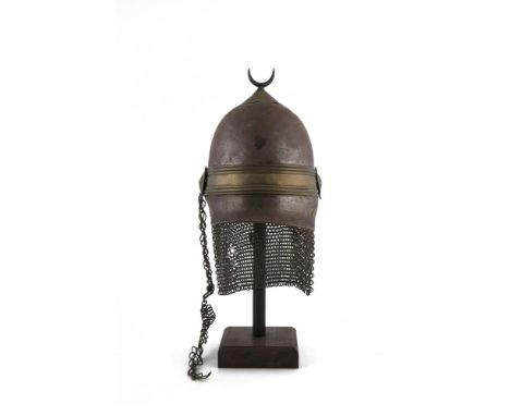 A KHEDIVIAL GUARD'S HELMET, 19th Century, the tall steel skull surmounted by a steel crescent on brass mount, the nasal bar i