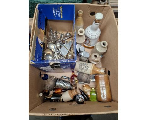 A box containing various miniature alcoholic beverages, a full Bells Whisky ceramic decanter, various stoneware bottles, and 